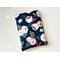 this flower book sleeve has a navy background with pink and light blue flowers and green leaves