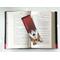 the laminated bookmark is in the middle of an open book