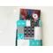 a small book peeking out of the blue patchwork book holder