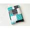 this patchwork book sleeve has blocks of black, gray, white and blue each block having different prints