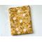 this floral tablet sleeve has a mustard yellow background with dandelions all over the tablet holder