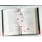this bug bookmark is lying on top of a open book
