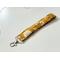 a side angle of mustard wristlet