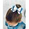 My 4 year old modeling a blue and white glitter 4 layer bow. Top left corner of bow has dripping iridescent blue rhinestones.