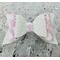 Close up of white glitter bow with pink & white ghost design, with very light pink lace ribbon. Bow is sold individually.
