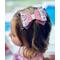 My 4 year old modeling a black glitter bow, with pink tulle, white with pink and black cute ghost print, w/ pink glitter and sequin on top.