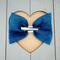 Back view of navy blue 4 x 3 glitter tulle hair bow. Brought together with a piece of white glitter faux leather.  Bow is sold individually.