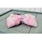 Side view for thickness & texture of floral inspired Soft pink, peach, blue, & yellow, hair bow, with Pink sparkle shell charm on top. 