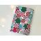 This Christmas book sleeve has a white background red, pink, blue & green hard candy