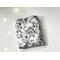 this floral kindle sleeve has a white background with black flowers and vines