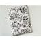 this floral tablet sleeve has a white background with black flowers and vines