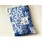 this quilted book sleeve has different shades of blues and white blocks. each block has a different print