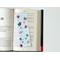 laminated bookmark is on a open book resting on a page