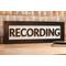 black wood recording studio LED light up lightbox and lamp sitting on desk for home studio, podcasters, musicians, and gamers