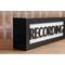 side view black wood recording studio LED light up lightbox and lamp sitting on desk for home studio, podcasters, musicians, and gamers