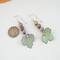 Super cute autumn earrings. Celebrate fall with these sweet dangles which have three teeny tiny copper enamel pumpkins of pastel green, orange, and lavender, with a pale green leaf swinging below. Super lightweight. Photo shows a dime for size reference.