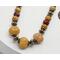 pumpkin shaped orange dyed quartz, brass accent, and sparkly diamond cut mookaite beads (brown and maroon) on brass chain with toggle clasp