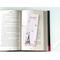 the pink page holder is on top of an open book on a white table