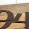 Close up of copper vein powder coat on our metal house number sign.