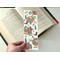 there are cowboy boots, hats, cacti, & small brown flowers all over the page saver. The book mark is laminated