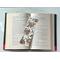 this cowboy bookmark is in the middle of the open book with fairy lights above the book
