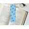 this floral bookmark with blue background with blue flowers all over the page holder