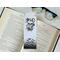 this scary book mark is on top of an open book with a pair of glasses  on a white table
