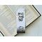 this skull bookmark has white marble background with spider web on of the book mark, a skull in the middle, and bats coming out of the dark