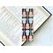 This guitar bookmark has a black background with light blue and light brown acoustic guitars covering the musical bookmark