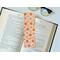 orange bookmark has light orange background with different shades of oranges flowers and polka dots