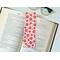 red bookmark has a light red background with different shades of red flowers, leaves and polka dots