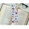 floral bookmark has a white background with different colors of flowers and leaves: orange (light and dark), blue (light and dark), and red