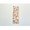 the floral bookmark is on a white table