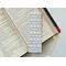 this elegant bookmark has a white background with small green leaves and light and dark pink roses all over the book mark