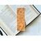 this yellow floral bookmark has a mustard yellow background with black outlines of flowers all over the bookmark
