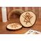 two wooden engraved coasters on coffee table with rune symbol inspired by yellowjackets television show, tv show prop