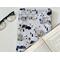 book pocket is on a white table with an open book on top and a pair of glasses on the left side