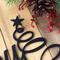 Close up of matte black powder coat on our Happy Holidays metal wall art.