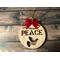 Handcrafted Peace Ornament cut from maple. Red velvety bow added. This ornament comes in a nice little giftbox with a clear window. 