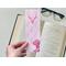 there are white cacti all over the page holder. this country bookmark is laminated