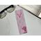 this cowgirl bookmark is on white table with an open book top right & fairy lights & glasses on the left side