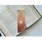 this owl bookmark has an ombre brown background with an owl reading a book in the middle & leaves in the bottom right and top left corner