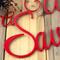 Close up of red gloss powder coat on our Unto Us a Savior is Born metal plaque.