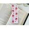 this pink western bookmark is on a white table