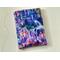 this castle book sleeve is purple with castles and waterfall all over the book holder.