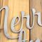 Close up of raw steel on our Merry Christmas metal sign.