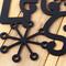 Close up of matte black powder coat on our Let it Snow metal sign.
