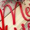 Close up of red gloss powder coat on our Merry Christmas metal sign.