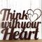 Close up of Think with your Heart metal sign, with two hearts, in copper vein powder coat.