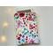 a ereader is peeking out of the watercolor kindle sleeve